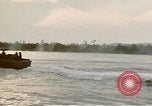Image of explosions along riverbank Vietnam, 1966, second 44 stock footage video 65675055555