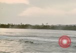 Image of explosions along riverbank Vietnam, 1966, second 46 stock footage video 65675055555