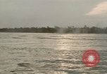 Image of explosions along riverbank Vietnam, 1966, second 47 stock footage video 65675055555