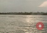 Image of explosions along riverbank Vietnam, 1966, second 49 stock footage video 65675055555