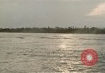 Image of explosions along riverbank Vietnam, 1966, second 50 stock footage video 65675055555