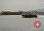 Image of explosions along riverbank Vietnam, 1966, second 52 stock footage video 65675055555