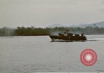 Image of explosions along riverbank Vietnam, 1966, second 53 stock footage video 65675055555