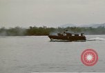 Image of explosions along riverbank Vietnam, 1966, second 54 stock footage video 65675055555