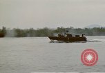 Image of explosions along riverbank Vietnam, 1966, second 56 stock footage video 65675055555