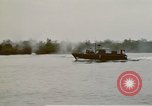 Image of explosions along riverbank Vietnam, 1966, second 58 stock footage video 65675055555