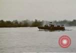 Image of explosions along riverbank Vietnam, 1966, second 59 stock footage video 65675055555