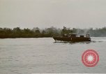 Image of explosions along riverbank Vietnam, 1966, second 60 stock footage video 65675055555