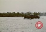 Image of explosions along riverbank Vietnam, 1966, second 61 stock footage video 65675055555