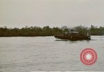Image of explosions along riverbank Vietnam, 1966, second 62 stock footage video 65675055555