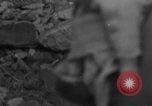 Image of Italian citizens in ruined village Italy, 1944, second 4 stock footage video 65675056390