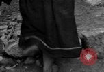 Image of Italian citizens in ruined village Italy, 1944, second 55 stock footage video 65675056390