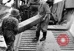 Image of US Soldiers labor and haul equipment Pacific Theater, 1944, second 34 stock footage video 65675056745
