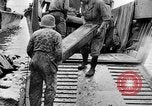 Image of US Soldiers labor and haul equipment Pacific Theater, 1944, second 36 stock footage video 65675056745