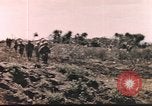 Image of US soldier assists wounded tank driver Iwo Jima Iwo Jima, 1945, second 3 stock footage video 65675057724