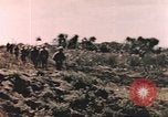 Image of US soldier assists wounded tank driver Iwo Jima Iwo Jima, 1945, second 4 stock footage video 65675057724
