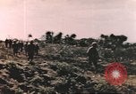 Image of US soldier assists wounded tank driver Iwo Jima Iwo Jima, 1945, second 7 stock footage video 65675057724