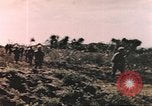 Image of US soldier assists wounded tank driver Iwo Jima Iwo Jima, 1945, second 8 stock footage video 65675057724