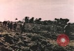 Image of US soldier assists wounded tank driver Iwo Jima Iwo Jima, 1945, second 9 stock footage video 65675057724