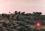 Image of US soldier assists wounded tank driver Iwo Jima Iwo Jima, 1945, second 10 stock footage video 65675057724