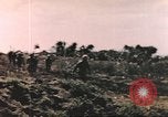 Image of US soldier assists wounded tank driver Iwo Jima Iwo Jima, 1945, second 11 stock footage video 65675057724