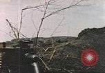 Image of US soldier assists wounded tank driver Iwo Jima Iwo Jima, 1945, second 20 stock footage video 65675057724