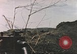 Image of US soldier assists wounded tank driver Iwo Jima Iwo Jima, 1945, second 21 stock footage video 65675057724