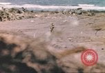 Image of US soldier assists wounded tank driver Iwo Jima Iwo Jima, 1945, second 24 stock footage video 65675057724