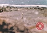 Image of US soldier assists wounded tank driver Iwo Jima Iwo Jima, 1945, second 36 stock footage video 65675057724