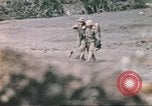 Image of US soldier assists wounded tank driver Iwo Jima Iwo Jima, 1945, second 43 stock footage video 65675057724