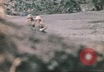 Image of US soldier assists wounded tank driver Iwo Jima Iwo Jima, 1945, second 48 stock footage video 65675057724