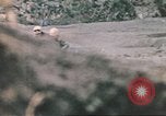 Image of US soldier assists wounded tank driver Iwo Jima Iwo Jima, 1945, second 49 stock footage video 65675057724