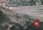 Image of US soldier assists wounded tank driver Iwo Jima Iwo Jima, 1945, second 50 stock footage video 65675057724