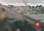 Image of US soldier assists wounded tank driver Iwo Jima Iwo Jima, 1945, second 56 stock footage video 65675057724