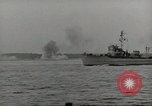 Image of planes dive bombing beach Pacific Theater, 1943, second 35 stock footage video 65675058376