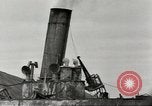 Immagine di Danni da bombardamento giapponese di Harbor olandese Aleutian Islands Alaska USA, 1942, secondo 35 filmato di repertorio 65675058382