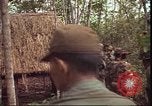 Image of thatched roof hut Pleiku South Vietnam, 1966, second 10 stock footage video 65675058783