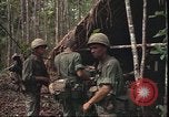 Image of thatched roof hut Pleiku South Vietnam, 1966, second 13 stock footage video 65675058783