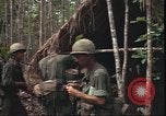 Image of thatched roof hut Pleiku South Vietnam, 1966, second 15 stock footage video 65675058783