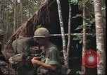 Image of thatched roof hut Pleiku South Vietnam, 1966, second 16 stock footage video 65675058783