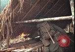 Image of thatched roof hut Pleiku South Vietnam, 1966, second 21 stock footage video 65675058783