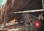 Image of thatched roof hut Pleiku South Vietnam, 1966, second 22 stock footage video 65675058783