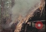 Image of thatched roof hut Pleiku South Vietnam, 1966, second 28 stock footage video 65675058783