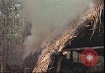 Image of thatched roof hut Pleiku South Vietnam, 1966, second 29 stock footage video 65675058783