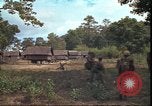Image of thatched roof hut Pleiku South Vietnam, 1966, second 43 stock footage video 65675058783