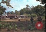 Image of thatched roof hut Pleiku South Vietnam, 1966, second 45 stock footage video 65675058783