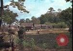 Image of thatched roof hut Pleiku South Vietnam, 1966, second 49 stock footage video 65675058783