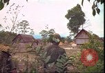 Image of thatched roof hut Pleiku South Vietnam, 1966, second 50 stock footage video 65675058783