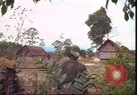 Image of thatched roof hut Pleiku South Vietnam, 1966, second 51 stock footage video 65675058783