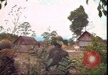 Image of thatched roof hut Pleiku South Vietnam, 1966, second 52 stock footage video 65675058783
